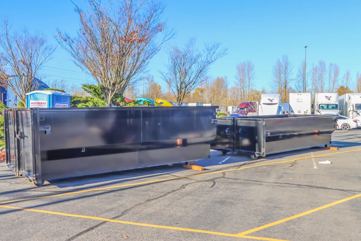 Professional dumpster rental service with roll-off container on residential driveway in Lonsdale